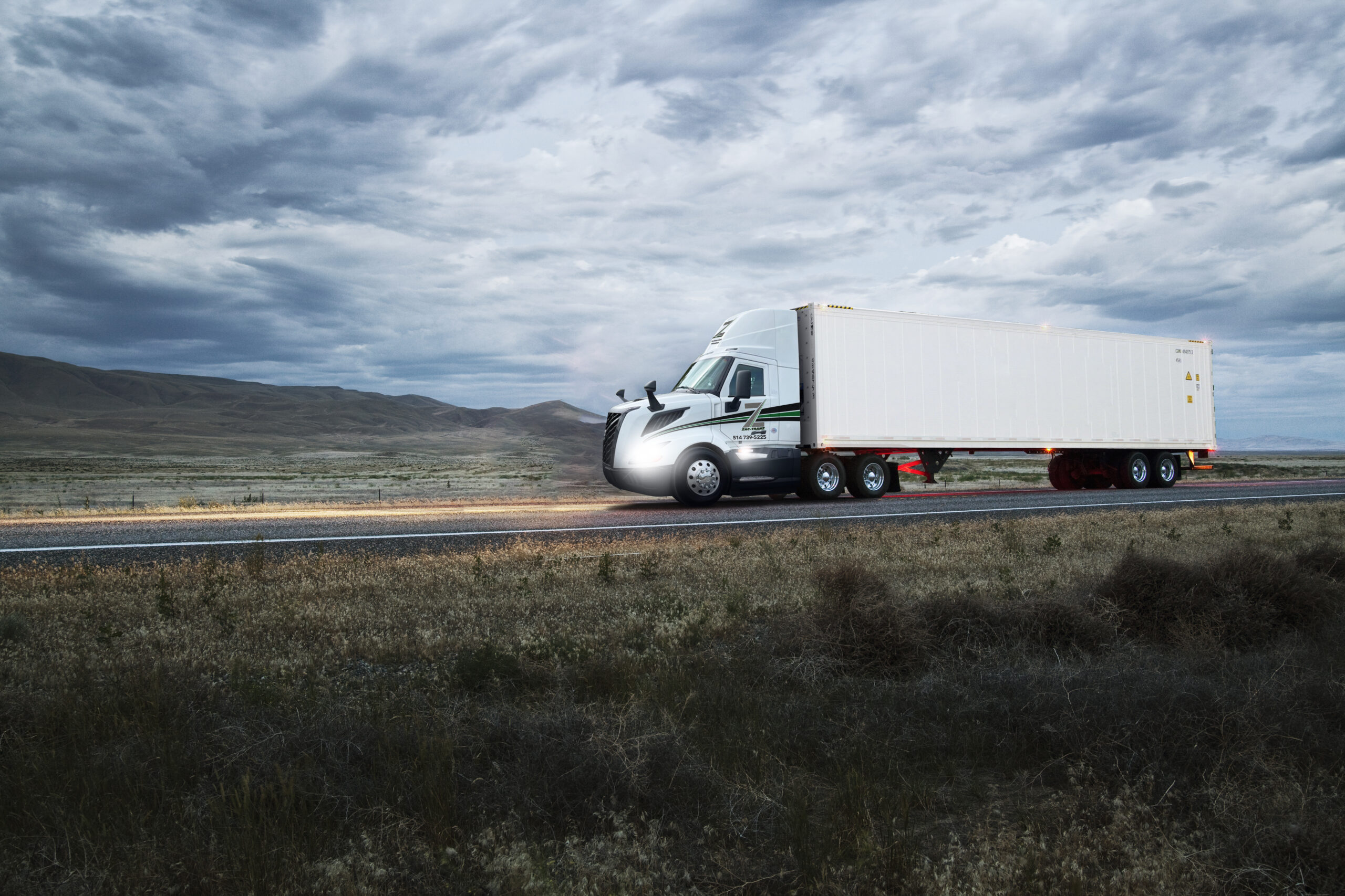 truck on a highway through the grasslands area of eastern Washington, USA.