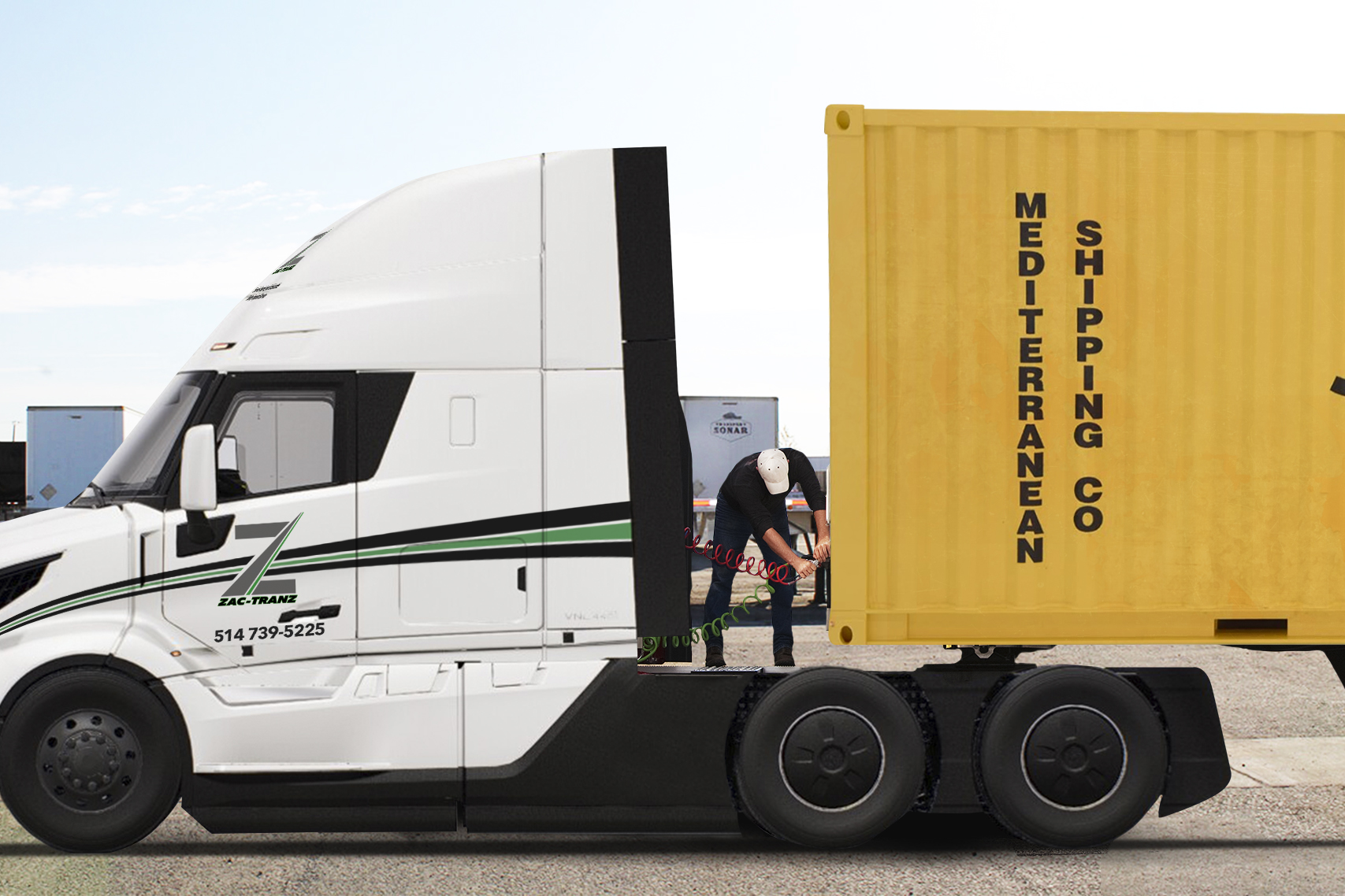 View of a driver connectiing the power cables to trailer of a  commercial truck.